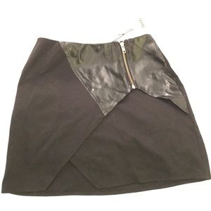 Never worn! Black mini skirt with leather detail